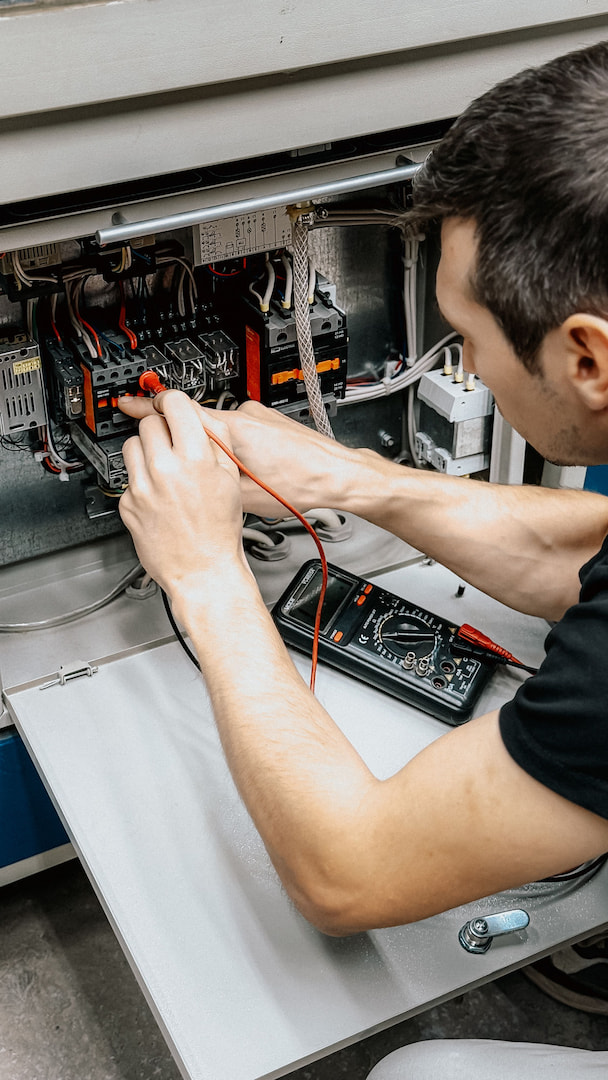 Technician working on an HVAC unit outdoors